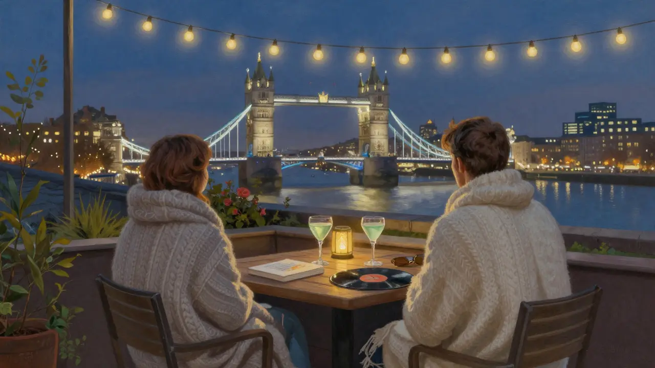 A quiet rooftop terrace at night with a couple wrapped in blankets, overlooking London’s skyline.
